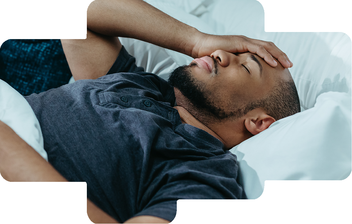 Man lying awake in bed, struggling to sleep
