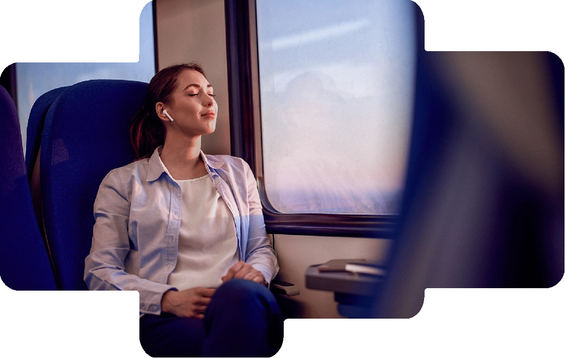 Woman listening to personalized sounds with earbuds on a train